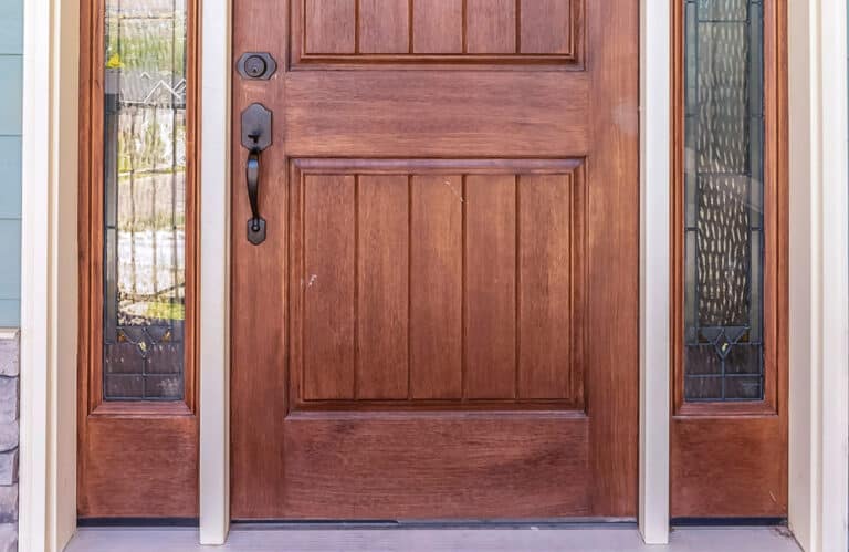 Wood front entry door with decorative glass sidelights